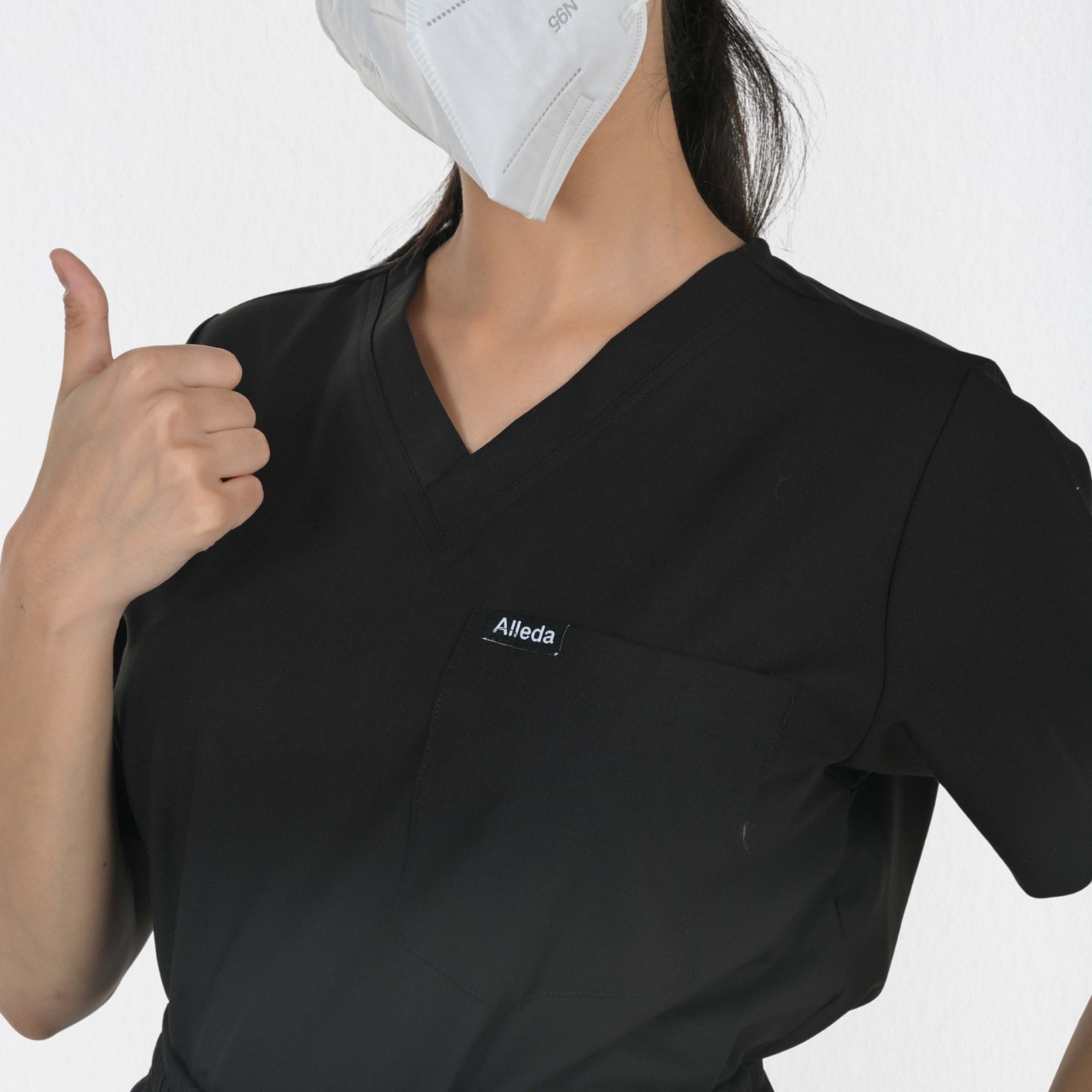 Alleda UltraFlex women's black scrub fabric close-up — 60% Polyester 34% Rayon 6% Spandex anti-pilling true black women's clinical workwear India