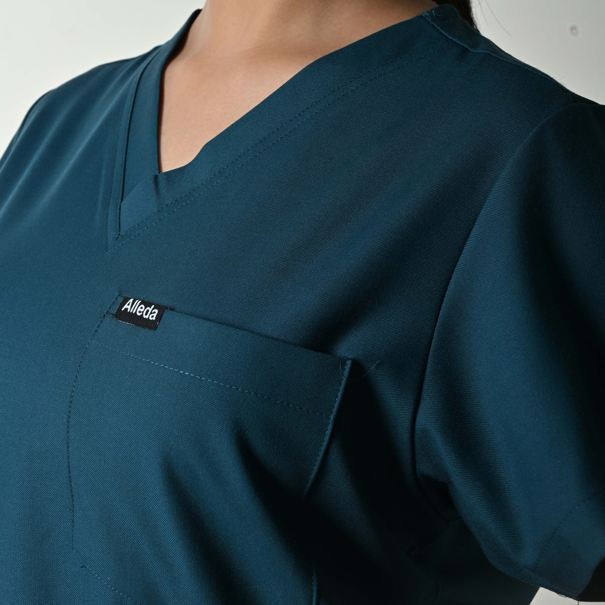 Alleda UltraFlex women's teal scrub fabric close-up — 60% Polyester 34% Rayon 6% Spandex anti-pilling teal women's clinical workwear flattering Indian skin tones