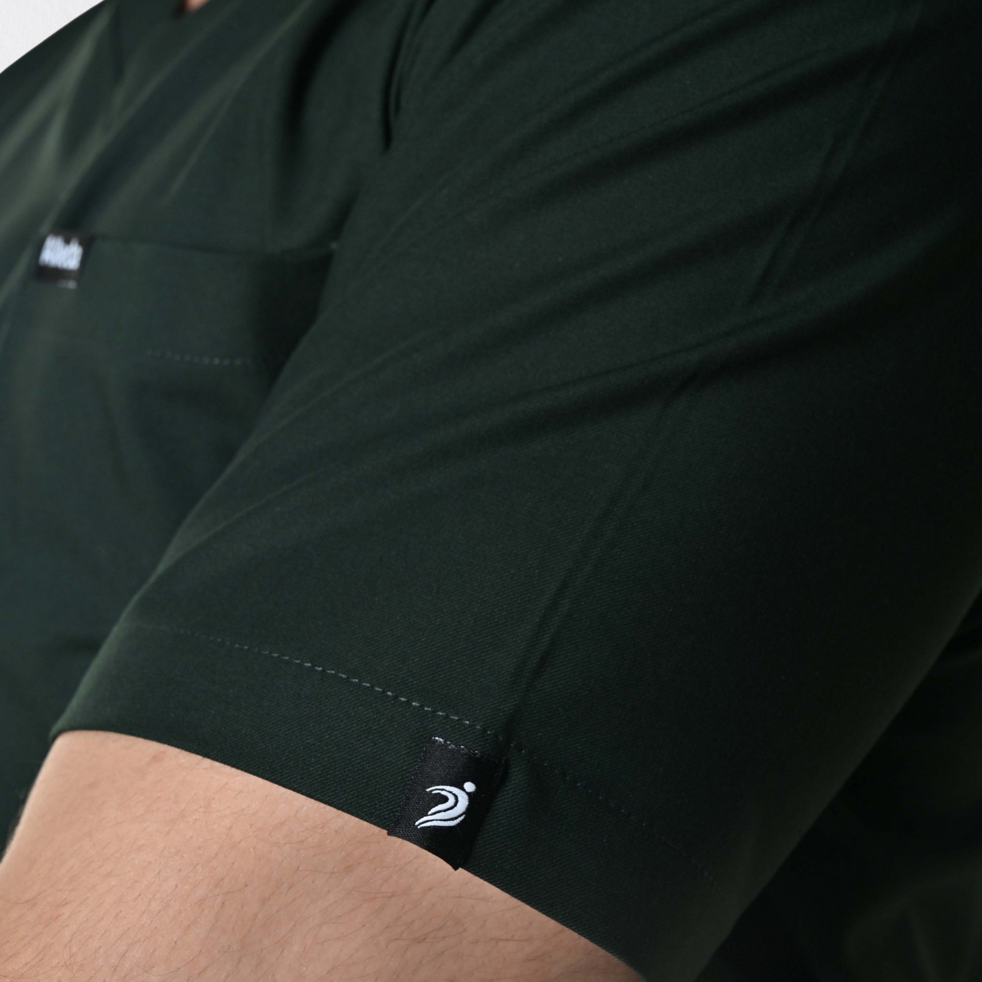 Alleda UltraFlex forest green scrub fabric close-up — 60% Polyester 34% Rayon 6% Spandex anti-pilling wash-stable deep green medical scrub India