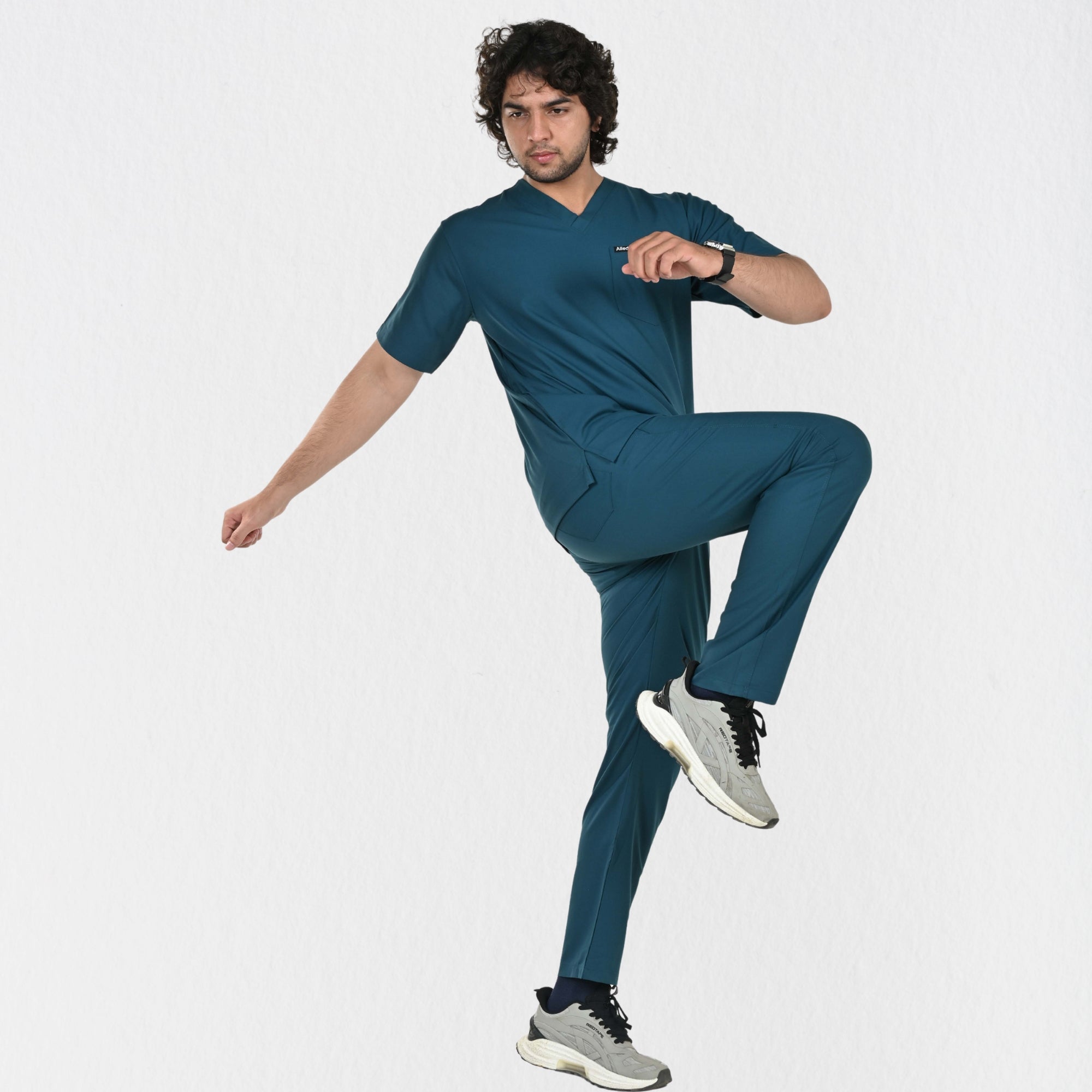 Men's teal 4-way stretch scrub set in motion — unrestricted movement for physiotherapists and doctors India