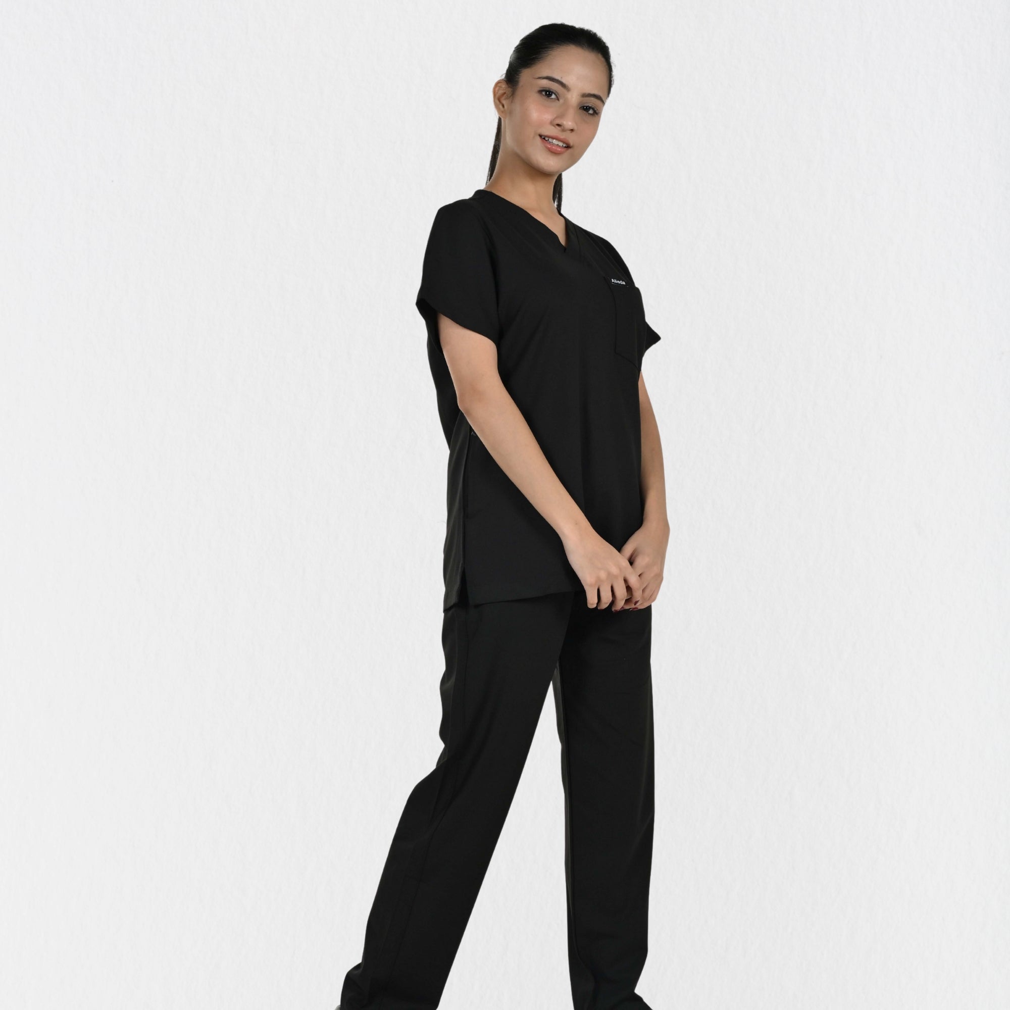 Alleda UltraFlex women's black V-neck scrub top — chest pocket and neckline detail, premium women's black medical scrubs independent sizing India

