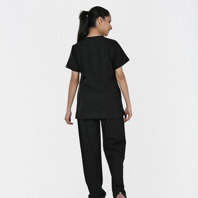Women's black 4-way stretch scrub set side view — tailored fit for female doctors physiotherapists, independent sizing black clinical workwear India
