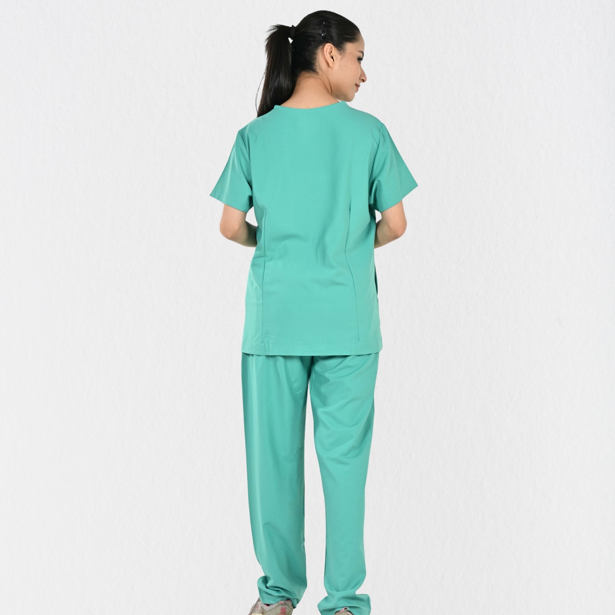 Women's surgical green 4-way stretch scrub set side view — tailored women's fit for female surgeons and doctors, unrestricted movement OT clinical workwear India
