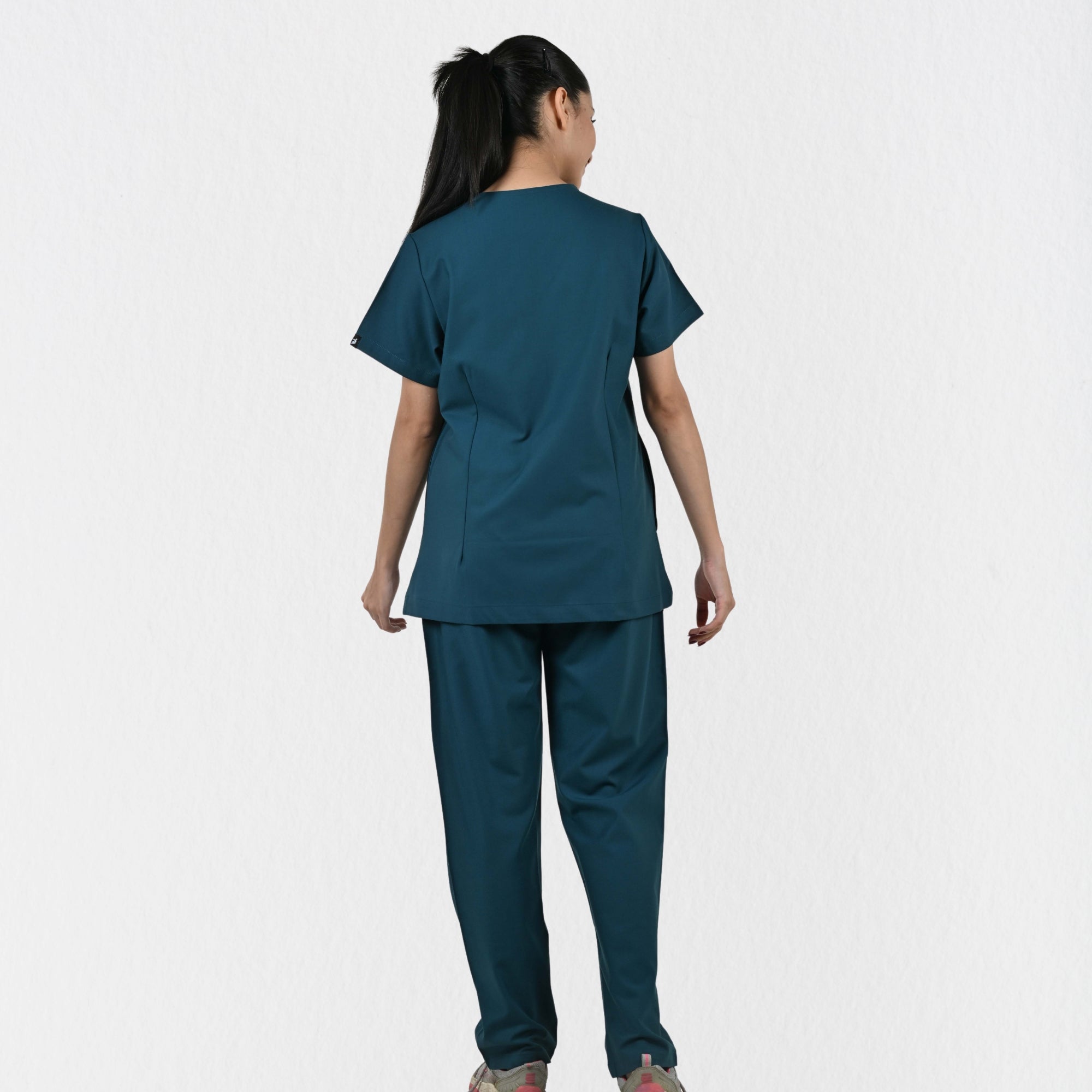 Women's teal 4-way stretch scrub set side view — tailored fit for female doctors and physiotherapists, independent sizing teal clinical workwear India
