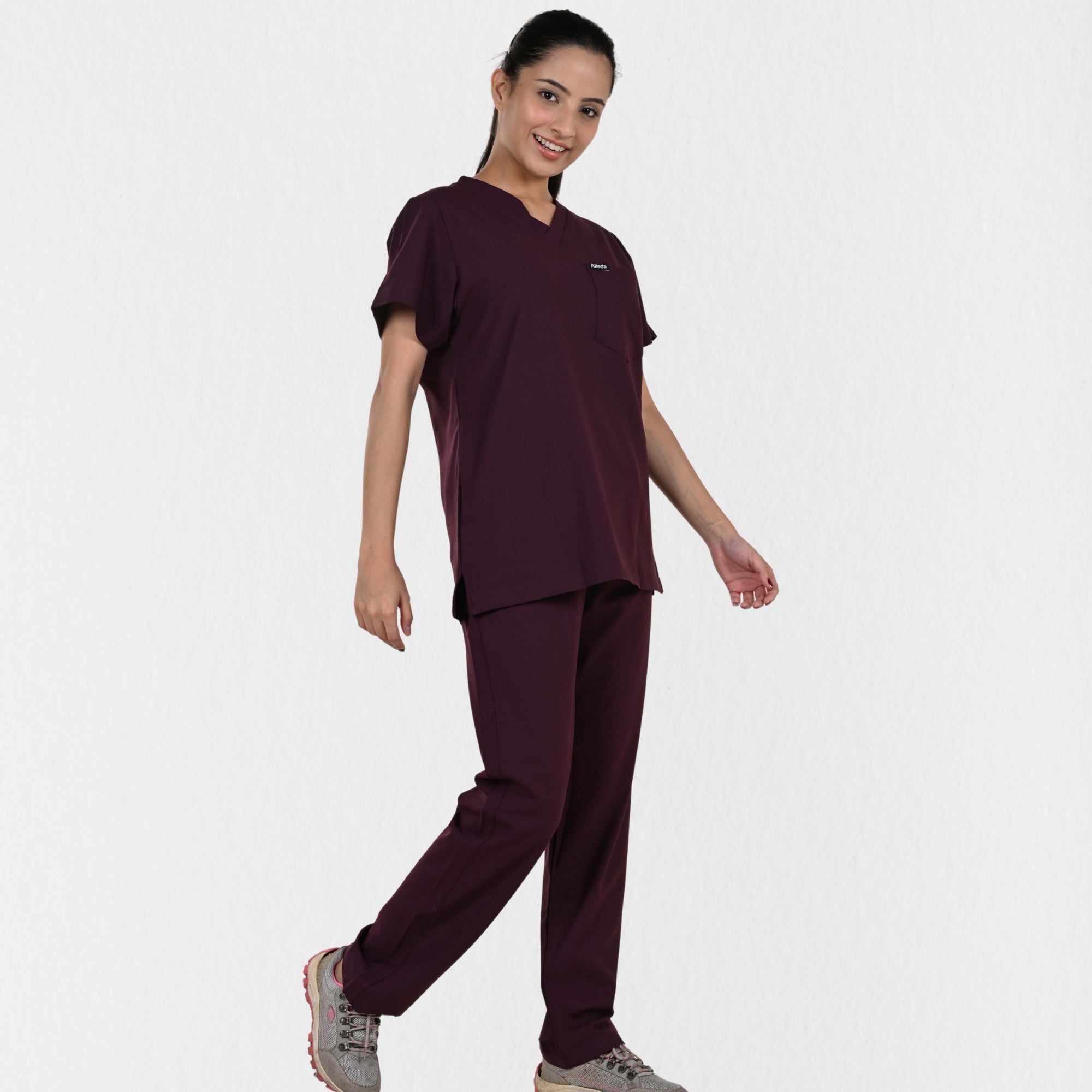 Alleda UltraFlex women's wine V-neck scrub top — chest pocket and neckline detail, premium women's maroon medical scrubs independent sizing India
