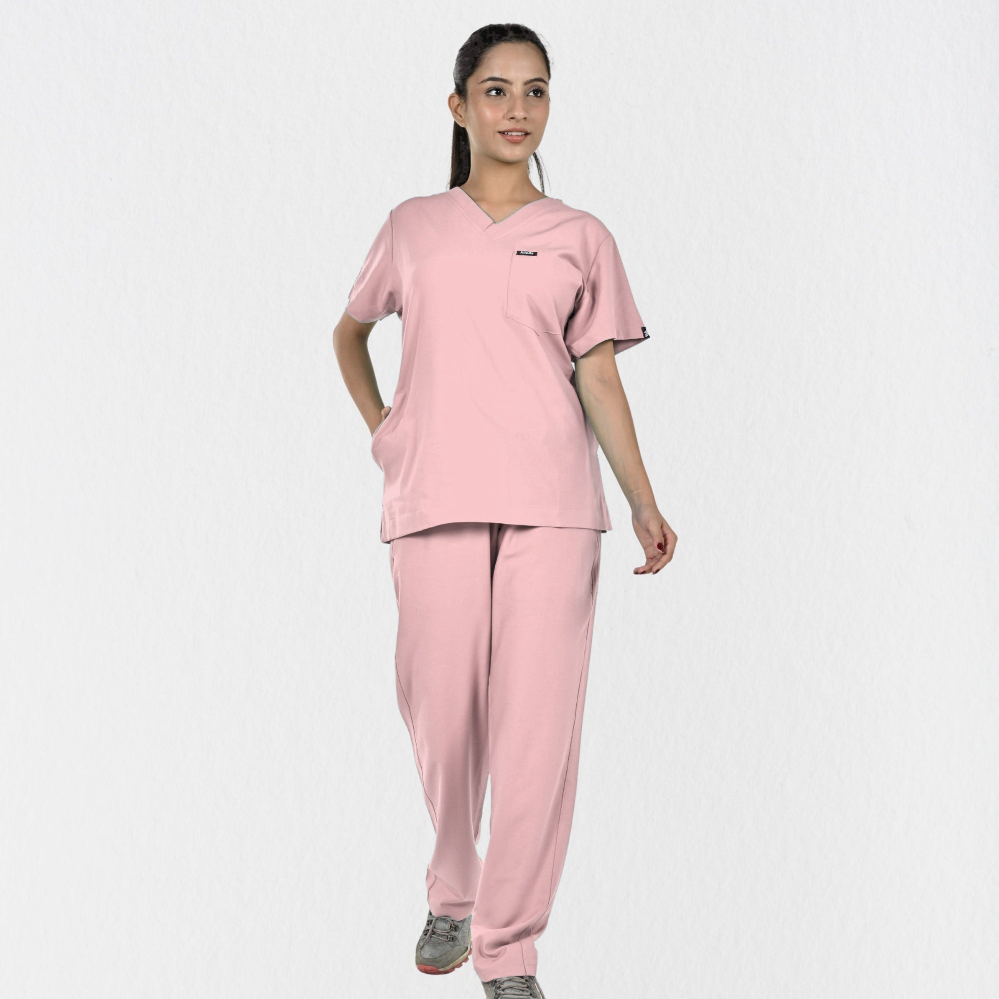 Alleda UltraFlex women's pastel pink 4-way stretch V-neck medical scrub set — hero front full-body view, best pink scrubs for women doctors India